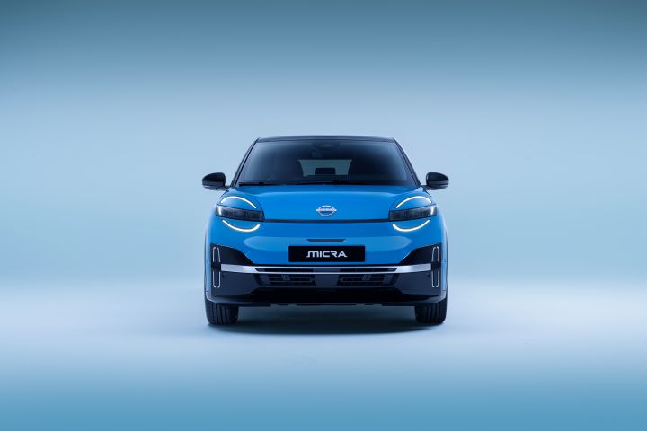full front view of All new Nissan Micra in a well-lit studio with only led signature headlamps on