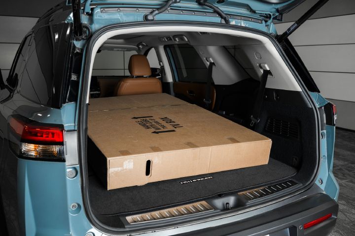 A 65-inch television inside the 2026 Nissan Pathfinder with the second and third row seats folded down.
