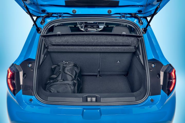 focused view of Micra trunk space with open trunk door, upright seats and black duffel bag in the corner