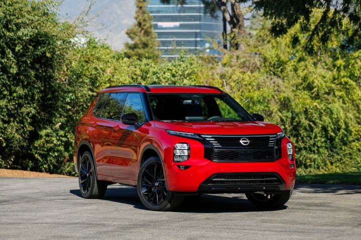 Front right 3/4 view of a red 2026 Nissan Rogue Plug-in Hybrid parked on asphalt.