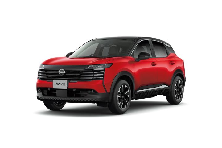 Studio shot of a red Nissan Kicks. The vehicle faces right, with a contrasting black roof emphasizing the two-tone design.