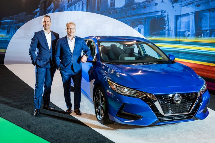 Steve Milette, president, Nissan Canada Inc.; Marc-André Nault, vice president, sales operations; standing in next to a Nissan Sentra.