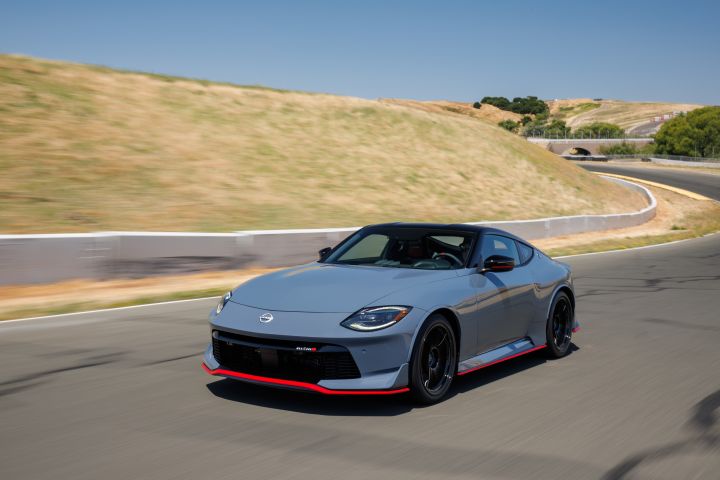 Nissan Z NISMO driving on a course with green hills in the background