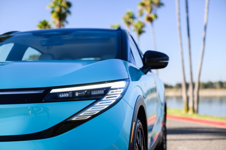 Close up of the left headlight on the 2026 Nissan LEAF, palm trees are behind.
