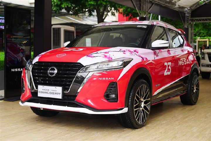 The Nissan Kicks e‑POWER Sakura / Formula E Edition on display at the Nissan Intelligent Mobility Tour in Bonifacio Global City, featuring a red and pink sakura-inspired livery, symbolizing Nissan’s Formula E triumph.