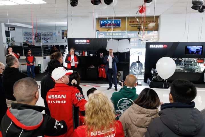 Aftersales director, Michael Hill alongside Dealer Principal Michael Banjanin with a microphone giving a speech to guests.