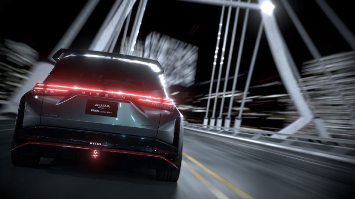 A silver and black two-tone sports car, the Aura Nismo RS Concept, viewed from the rear as it speeds straight ahead across a bridge. The taillights glow in a vivid red horizontal line, and the rear center features a black plate with white text reading 'AURA NISMO RS CONCEPT.' A red accent line and the NISMO logo are visible on the lower bumper. The background shows streaks of light, emphasizing speed and dynamic motion