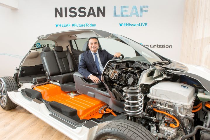 Carlos Ghosn inside a Nissan LEAF model