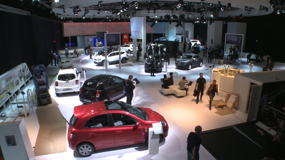 Showroom with people walking around cars