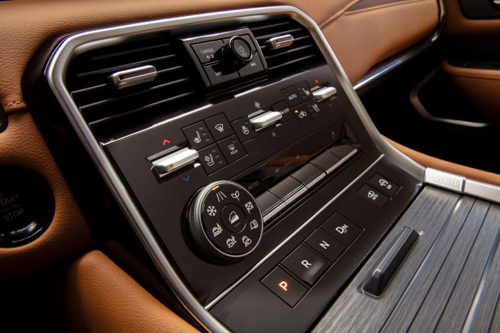 The center dashboard controls and accordion space cover inside the 2025 Nissan Armada.