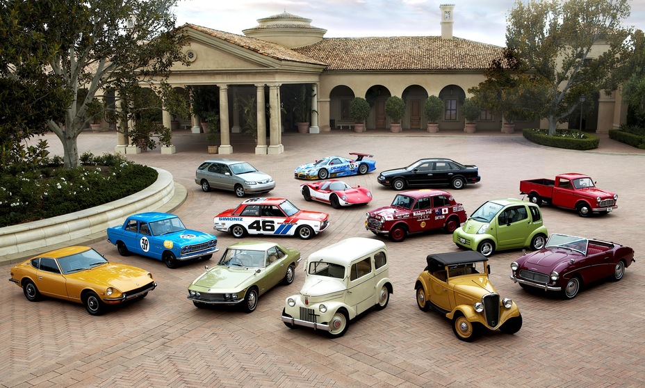 several Nissan vehicles parked outside a residence