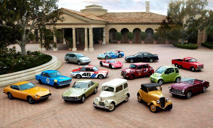 several Nissan vehicles parked outside a residence