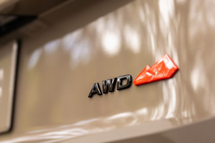 Close up of All wheel drive decal on a tan 2025 Nissan Rogue rock creek.
