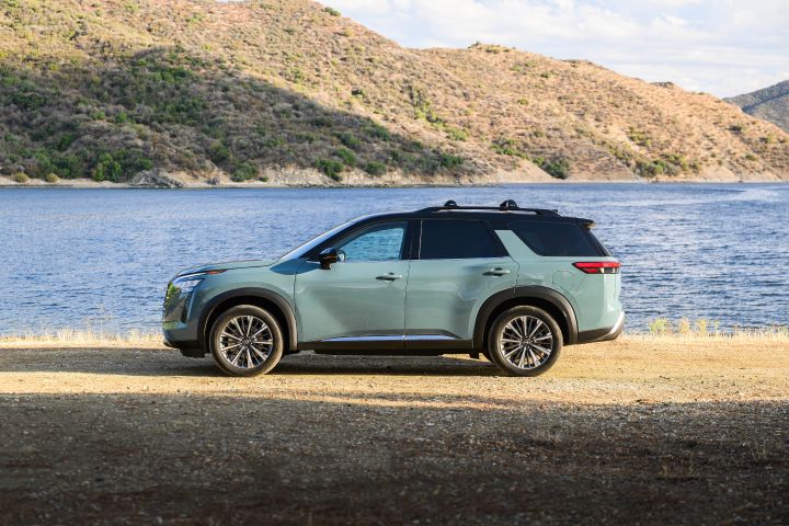 Left profile view of the 2026 Nissan Pathfinder parked in front of a large body of water.