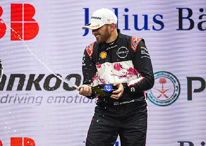 Oli spraying champagne on the podium