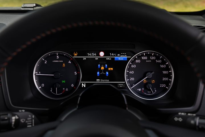 2026 Nissan Navara PRO-4X finished in Boulder Grey highlighting the gauge cluster with low-range four-wheel-drive monitor and wheel-status graphic.