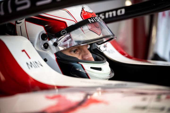 Gabriele Mini sits in the car in the garage during Rookie Free Practice, with his helmet on