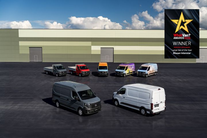 Group shot of Nissan Interstar van range, including a selection of factory conversions parked outside a warehouse, with the What Van awards logo in the top right corner of the image