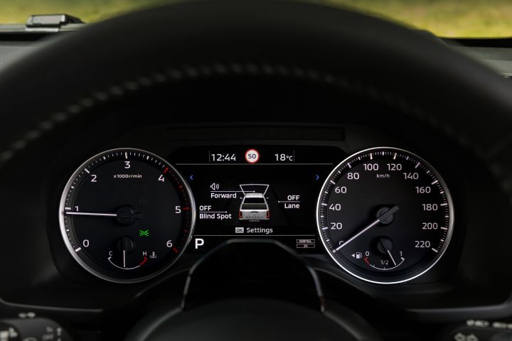2026 Nissan Navara PRO-4X finished in Boulder Grey featuring the driver display with safety-system settings for forward assistance, blind spot and lane functions.