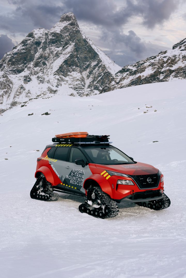 Vertical shot of Nissan X‑Trail Mountain Rescue on snow in front of mountains