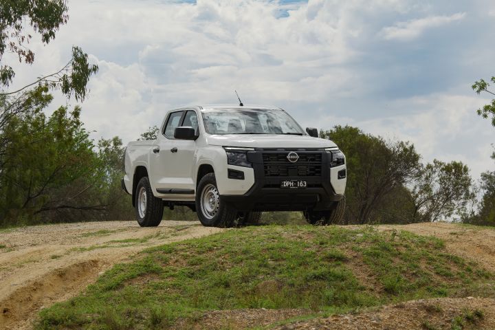 Front distant angles shot of a 2026 Nissan Navara in Alpine White paint