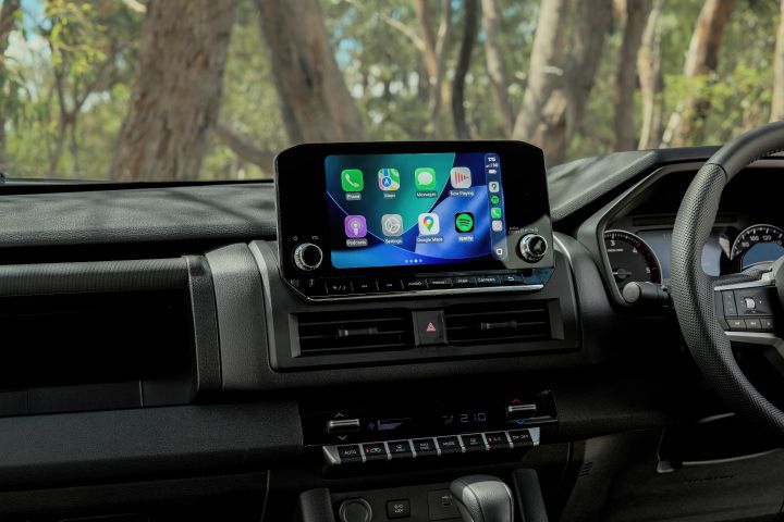 2026 Nissan Navara ST dual cab ute finished in Summit Silver displayed from the passenger-side interior angle, showing front seats, console and dashboard design.