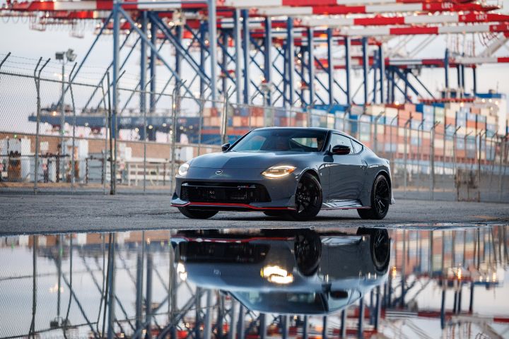 Front left 3.4 view of the 2027 Nissan Z NISMO MT parked on a raceway with water reflecting in front of it.