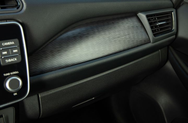 The sleek passenger side dashboard area inside the 2025 Nissan LEAF.