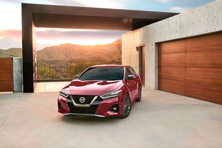 A red 2019 Nissan Maxima parked in a driveway
