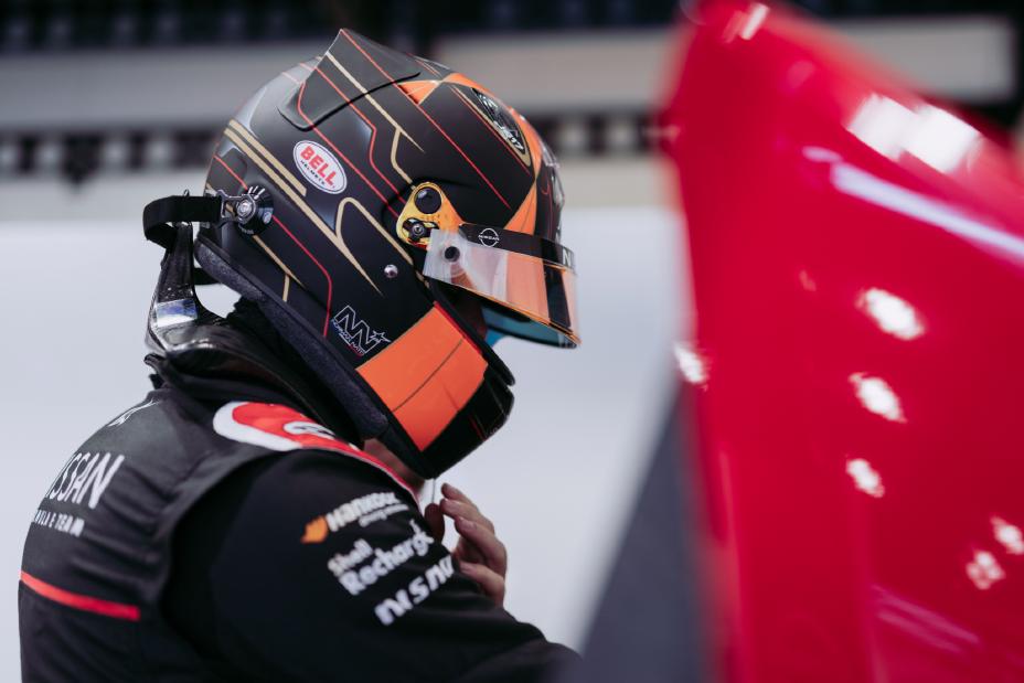 Nissan formula E driver adjusting helmet