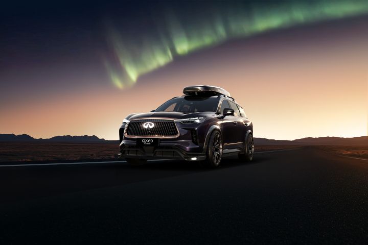 the INFINITI QX60 Concept SUV on a highway with green Arctic Aurora light effect in the sky above