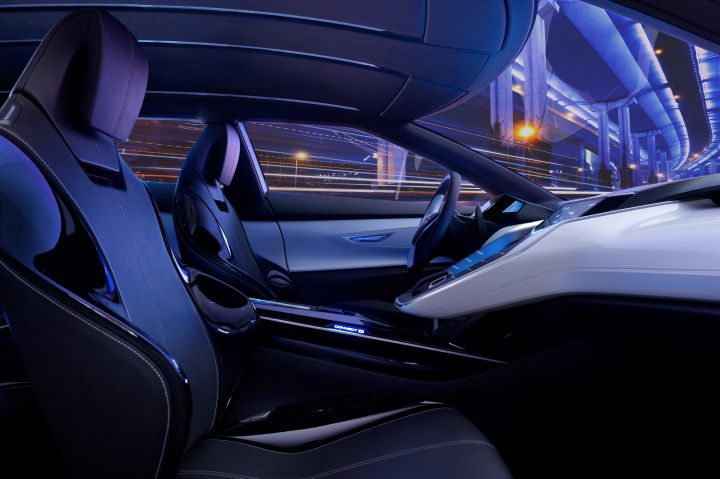 passenger side view of the front interior of a vehicle in blue lighting