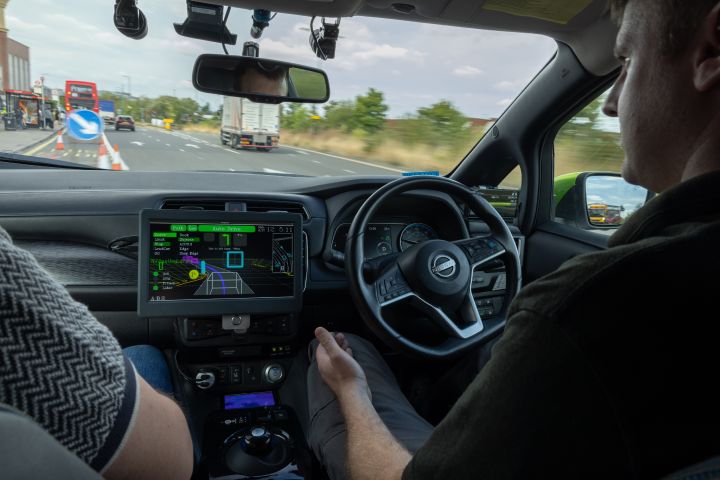 Dynamic shot of evolvAD safety driver on suburban route