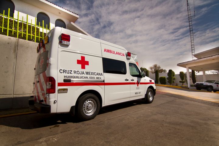 a Nissan NV2500 ambulance next to a residence