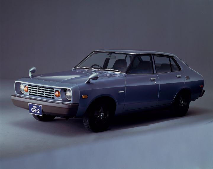 photo of a vintage gray GR vehicle posed in front of a gray backdrop photoshoot