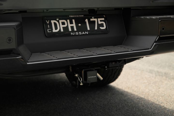 2026 Nissan Navara PRO-4X finished in Boulder Grey highlighting the rear bumper, number plate recess, parking sensors and factory tow hitch.