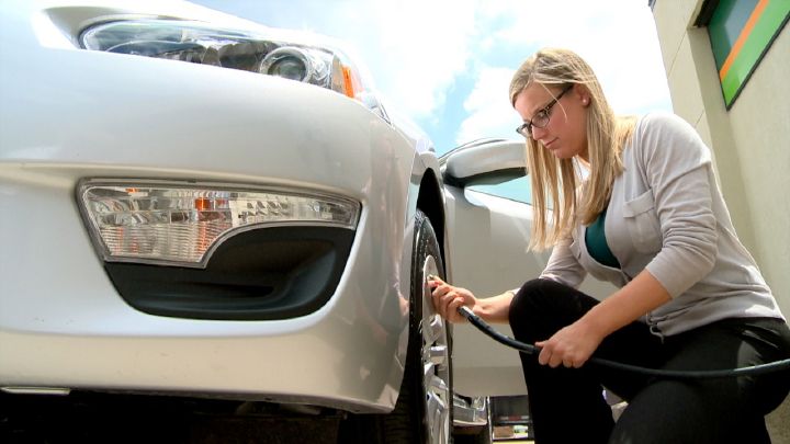 Woman filling up tire