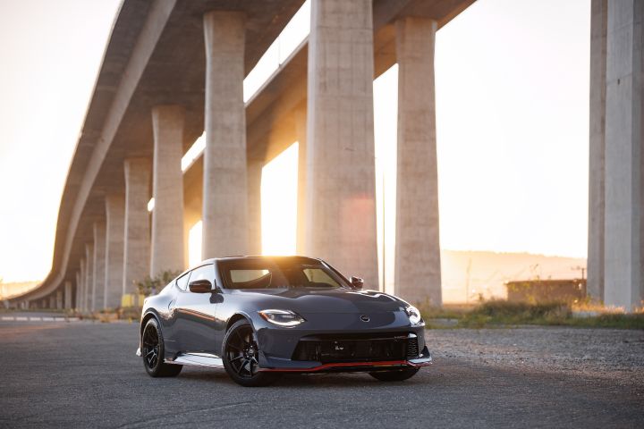 Front right 3/3 view of the 2027 Nissan Z NISMO MT parked near a bridge at sunset.