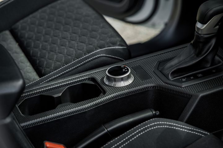 2026 Nissan Navara SL dual cab ute finished in Alpine White with a close view of the centre console, gear selector, rotary controller and cupholder area.