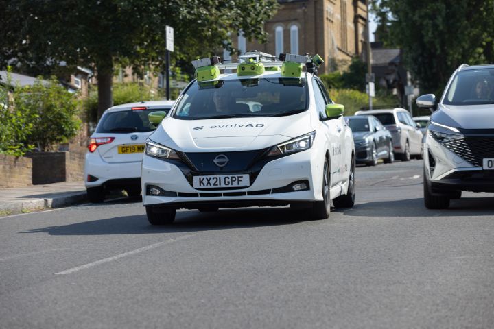 Dynamic front shot of evolvAD on a residential route going down a hill