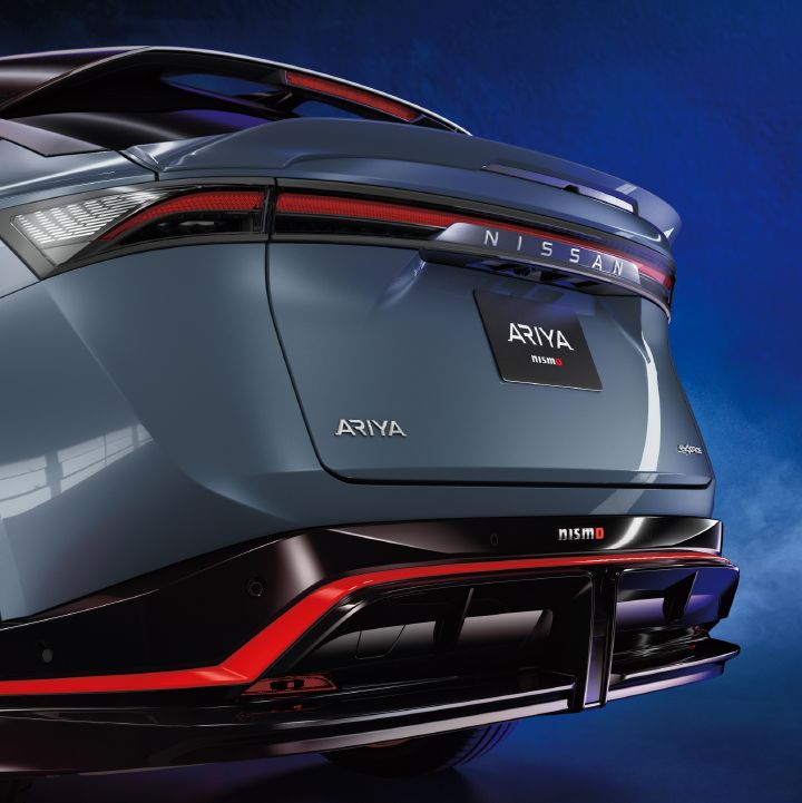 Static (studio shot) of Ariya NISMO; side - back shot showing the rear bumper, Nismo logo and twin diffuser