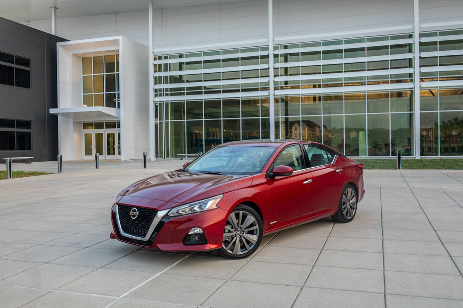 A Nissan Altima Edition ONE parked in front of a building
