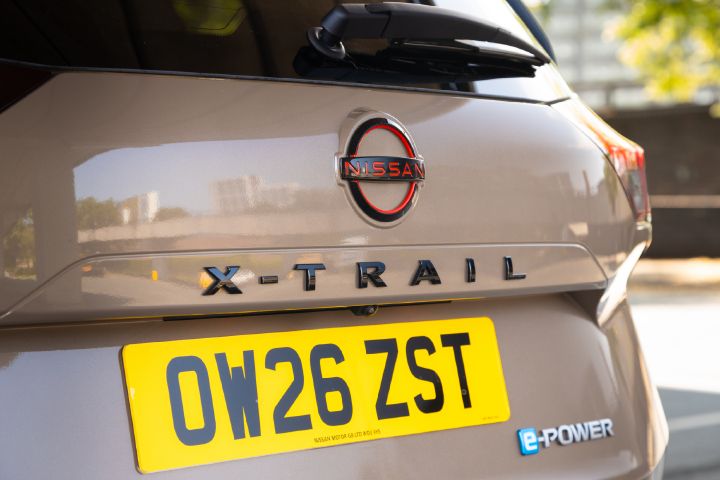 Close-up of the rear of a Nissan X‑Trail, highlighting the Nissan badge, X‑Trail model lettering and e‑POWER badge above the rear number plate.