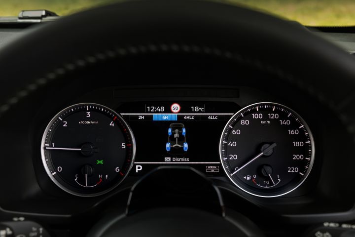 Front-on view of the 7-inch TFT Display Instrument Cluster in a 2026 Nissan Navara ST‑X, showing the four-wheel-drive status screen with drivetrain options and a vehicle diagram in the centre.