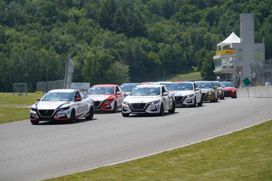 Several Nissan Sentra racing cars on the track.