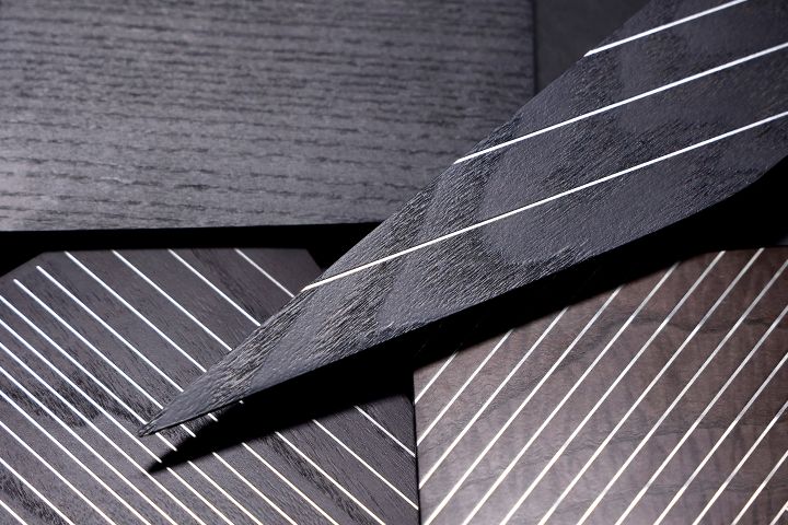 Four woodgrain samples from within the INFINITI QX80 positioned on top of each other.
