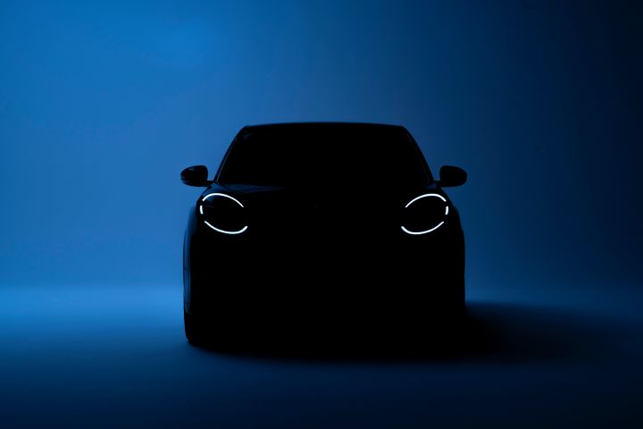 teaser image of All new Nissan Micra in the dark with only led signature headlamps in front on