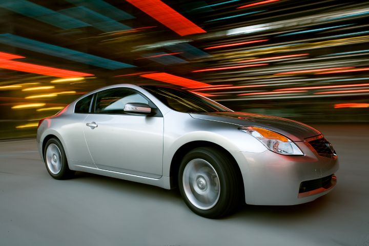a 2008 Nissan Altima Coupe parked next to a bright background