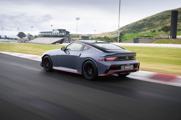 Angled rear view of the 2027 Nissan Z NISMO Manual Transmission speeding along a racetrack.