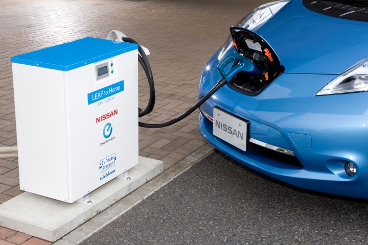 a blue Nissan LEAF charging in a power station